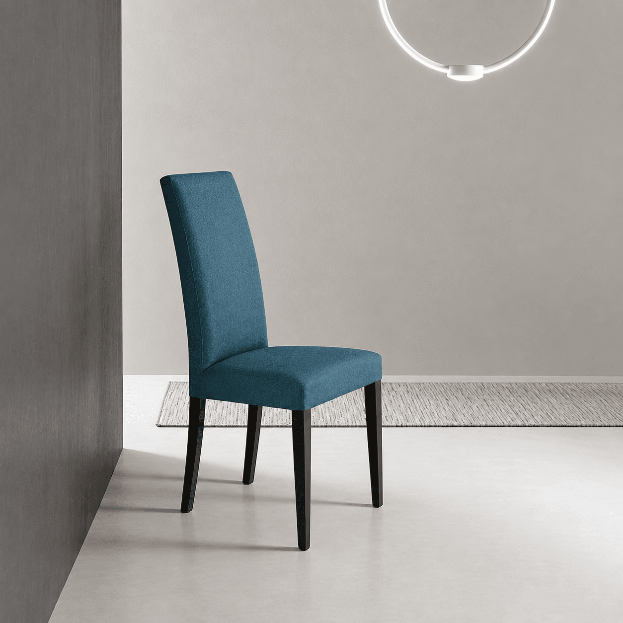 Denver dining chair fully upholstered in teal fabric with dark wood legs, in a minimal grey room